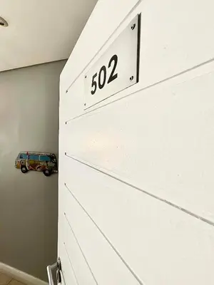 a white drawer with a clock on top of it at 502 Portico in Cape Town