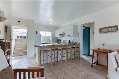 a kitchen with white cabinets and a counter top at 30 Nagua Bay in Cape Town