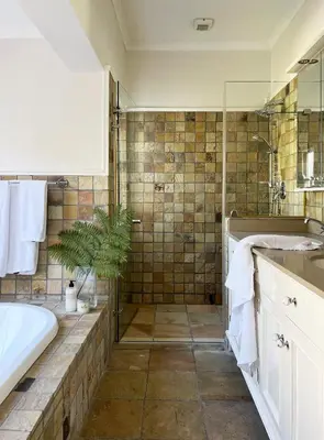 a bathroom with a tub and a sink and a shower at La Belle Vie in Franschhoek