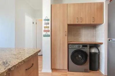 a kitchen with a washing machine in a kitchen at Oak on Main in Hermanus