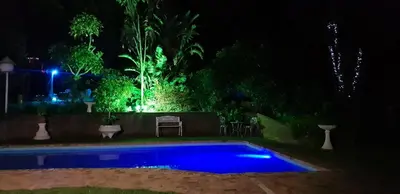 a swimming pool at night with lights on it at Relax on Blair in Cape Town