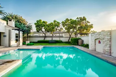 a swimming pool in the backyard of a house at Belina - Bougain Villas Premier in Cape Town