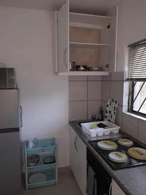 a kitchen with a counter top with plates on it at Oxford Getaway-House in Cape Town