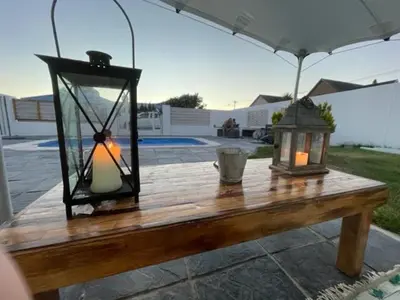 a wooden table with two lanterns on top of it at Perfect long stay,near Rondevlei nature reserve,wifi in Cape Town