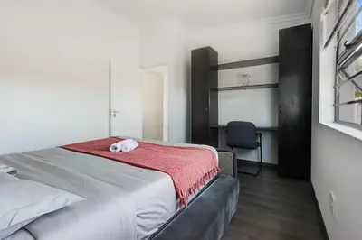 a bedroom with a bed with two towels on it at Spacious Shared 3-Bedroom Villa Near Blouberg Beach Pool, Wi-Fi, Braai in Cape Town