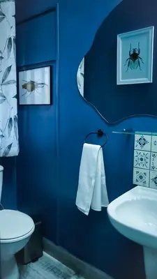 a blue bathroom with a sink and a toilet at 1-bedroom apartment with secure basement parking in Stellenbosch