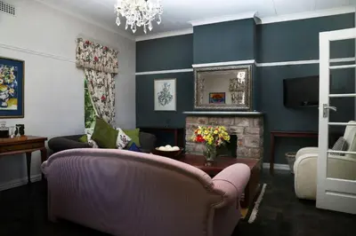 a living room with a couch and a fireplace at Pat's Place in Hermanus