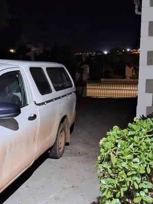 a white car parked next to a building at night at Prince Alfreds in Caledon
