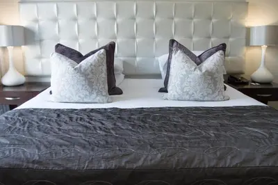a bed with two pillows on top of it at Harbour House Hotel - Adventure Pads in Hermanus