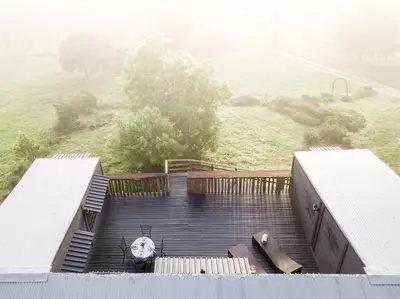 a view from the top of a building with some stairs at Avemore Vineyard View - wood fired hot tub and full power back up in Onder-Papegaaiberg