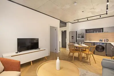 a living room with a television and a table with chairs at Bridgewater View 502 in Cape Town
