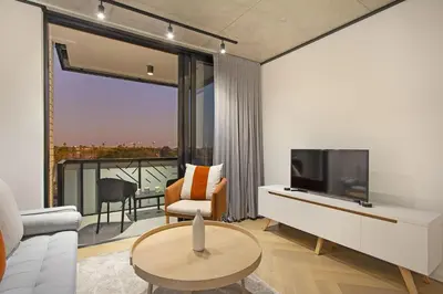 a living room with a tv and a couch and a table at Bridgewater View 502 in Cape Town