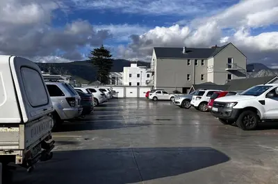 a parking lot with a lot of cars parked at Hermanus Waterfront Apartment No.19 in Hermanus
