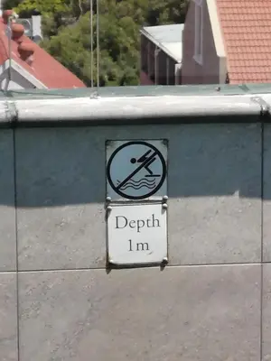 a sign on a wall that says depth im at Hermanus Waterfront Apartment No.19 in Hermanus
