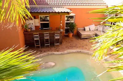 a small swimming pool in the backyard of a house at Surfhostel Cape Town in Cape Town