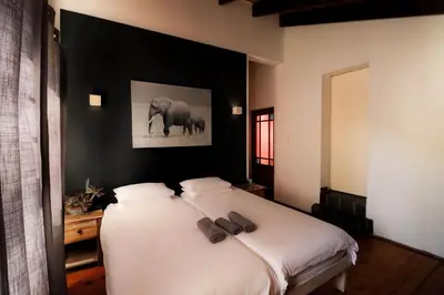 a bedroom with a bed with two shoes on it at Surfhostel Cape Town in Cape Town