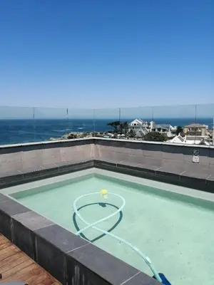 a swimming pool with a tennis ball in it at Hermanus Waterfront Apartment No.20 in Hermanus
