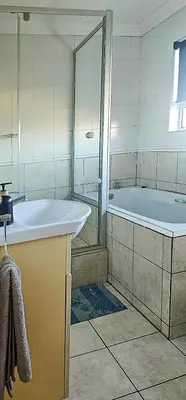 a bathroom with a tub and a sink at OCEAN VIEW, Blouberg Beach, Sunsets & Kite Beach in Bloubergstrand