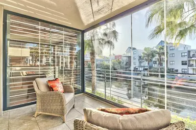 a living room with a large window with a view of the city at 2 Bedroom Apartment in Century City 204QS in Cape Town