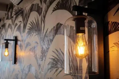 a couple of lights are hanging on a wall at Beachfront Gem / Free Parking / A/C in Cape Town