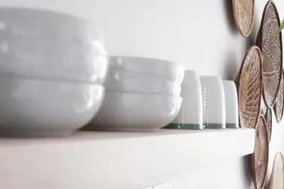 a shelf with bowls and plates on it at Quiet hidden gem in historic Stellenbosch in Stellenbosch
