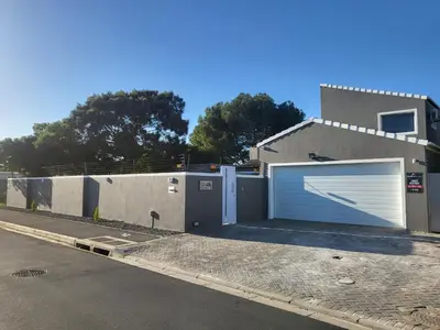 a garage with a white garage door on a house at Willow Retreat Blouberg in Cape Town