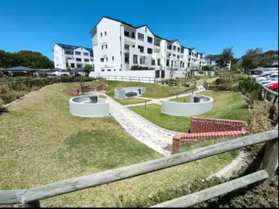 a large yard with some buildings in the background at Casa The Jade in Cape Town