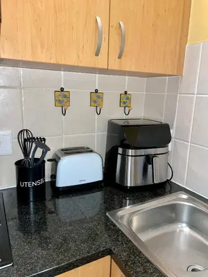 a kitchen counter with a toaster and a sink at Blouberg Beach Luxury Apartment in Cape Town