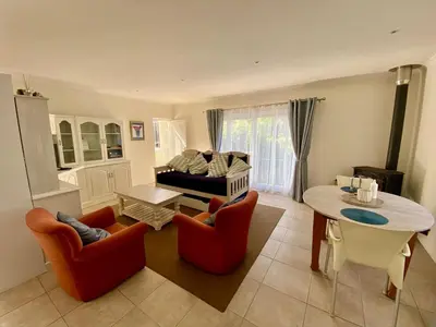 a living room with two chairs and a table at Bing Heights Suite in Hermanus