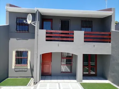 a facade of a building with red doors at Capetown Adilo Villa in Cape Town