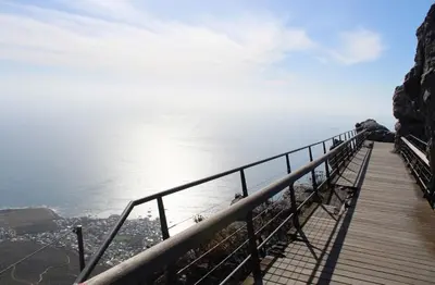 a boardwalk on the edge of a mountain overlooking the water at Capetown Adilo Villa in Cape Town