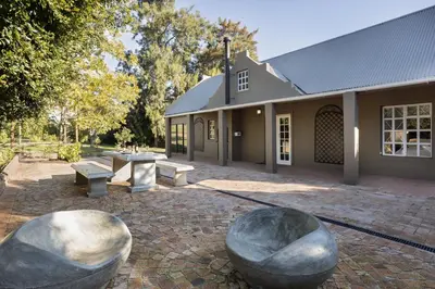 a building with two large metal spheres in front of it at Avemore Winelands Home - wood fired hottub and full power back up in Stellenbosch