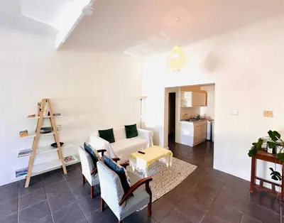 a living room with a couch and a table at 2-Bedroom Hermanus - Sleeps 4 - Near Sea in Hermanus