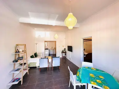 a living room with a couch and a dining room at 2-Bedroom Hermanus - Sleeps 4 - Near Sea in Hermanus