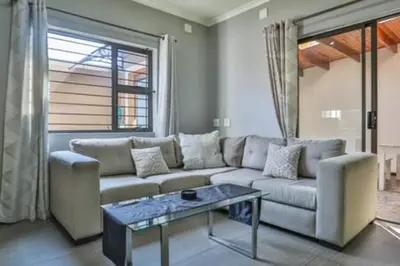 a living room with a couch and a table at Howard Davis 28B by CTHA in Cape Town