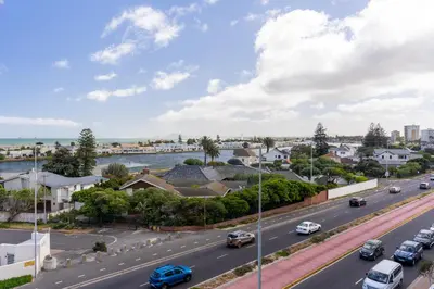 a view of a city street with cars on the road at Burmeister 401 - 2 Bedroom Apartment across from Ocean - Onsite Parking in Cape Town