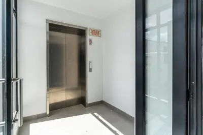 a hallway with an elevator in a building at Burmeister 401 - 2 Bedroom Apartment across from Ocean - Onsite Parking in Cape Town
