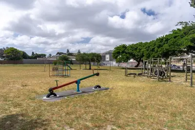 an empty park with a playground in a field at Burmeister 607 - Top Floor Corner 2 Bedroom Apartment with Sea and Lagoon Views - Onsite Parking in Cape Town
