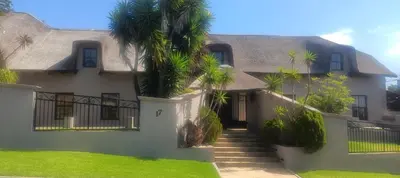 a house with palm trees in front of it at Traduire in Cape Town