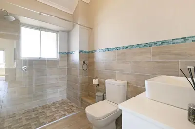a bathroom with a toilet and a sink at Sea Spray B404 in Cape Town
