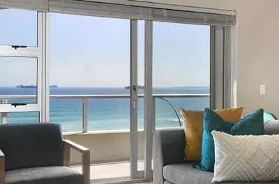 a living room with a view of the ocean at Sea Spray B404 in Cape Town