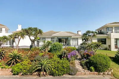 a house with a garden in front of it at On the Greens Villa in Cape Town
