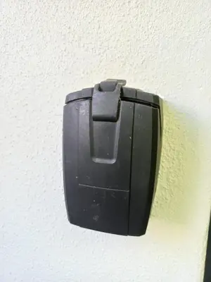 a black electrical outlet on the side of a wall at Lucano 1 Stellenbosch in Stellenbosch