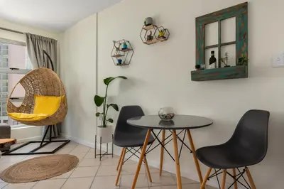 a dining room with a table and chairs at Ocean View B201B in Cape Town
