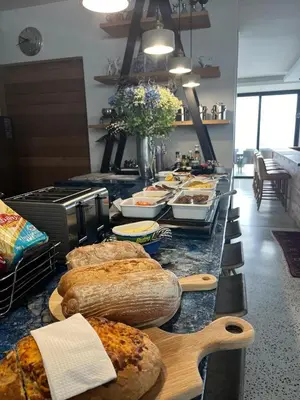 a buffet with many different types of bread on a counter at Boutique Ocean Views - incorporating Wendy's in Hermanus
