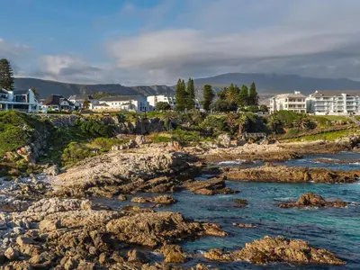 a view of a beach with rocks and houses at Boutique Ocean Views - incorporating Wendy's in Hermanus