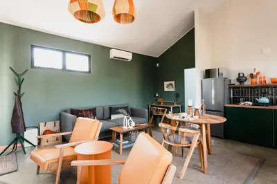 a living room with a table and chairs at untether on Olive View in Wellington