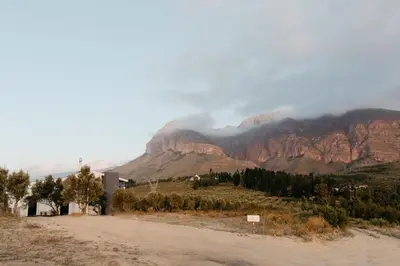 a dirt road with a mountain in the background at untether on Olive View in Wellington