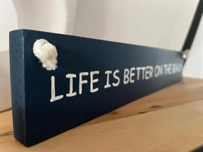 a black box with the words life is better on it at Kite, Wind, Waves Beach Villa in Cape Town