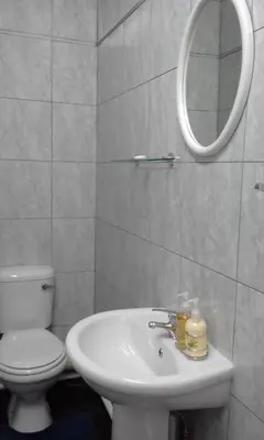 a bathroom with a sink and a toilet and a mirror at 68 On Hofmeyr in Strand